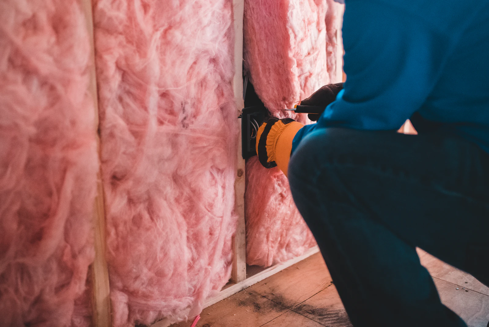 A technician operating an insulation blower machine